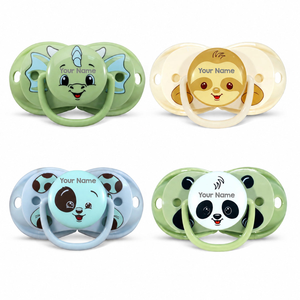 Four customizable baby pacifiers arranged in a 2x2 grid on a white background. Each pacifier has a different animal face design: a green dinosaur, a cream monkey, a light blue panda, and a green panda.